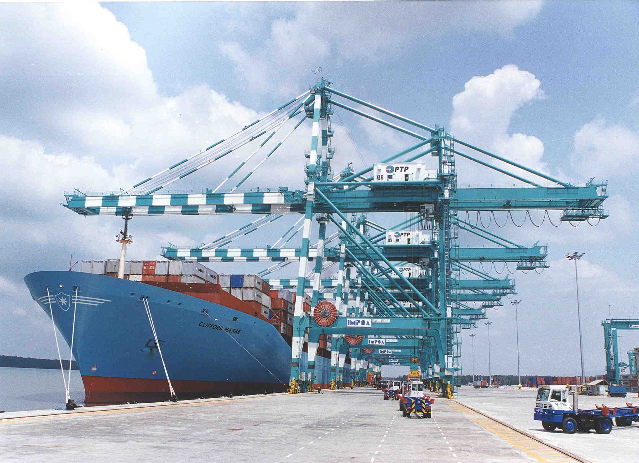 Port cranes loading a container ship